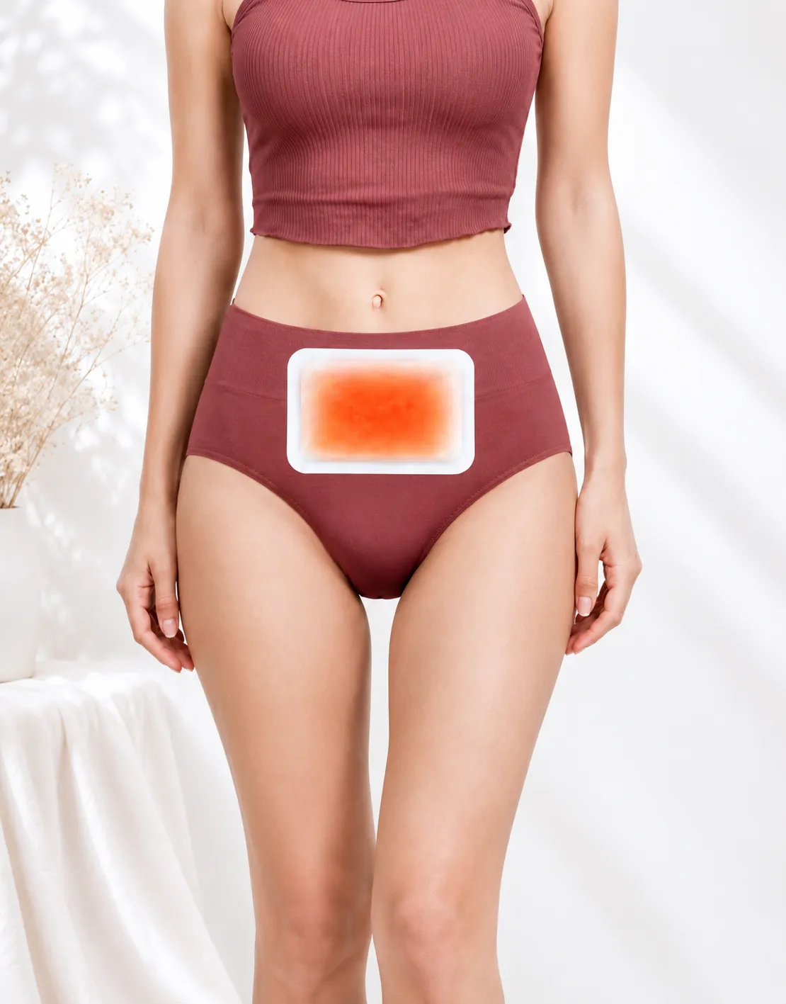 Warm patch applied to the lower abdomen, worn with high-waist leggings for everyday comfort