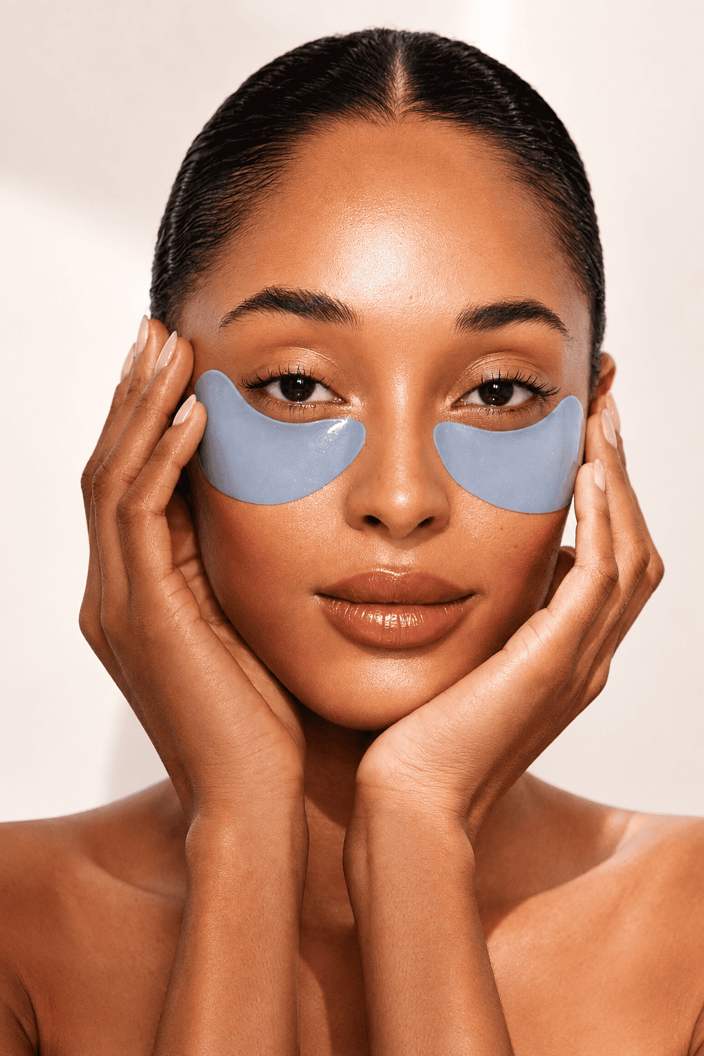 Close-up of a woman wearing blue under-eye patches